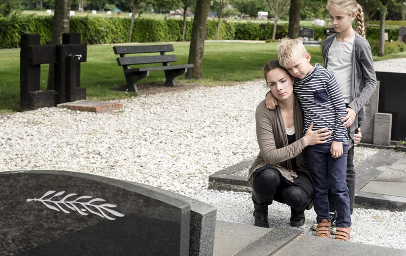 Family at gravesite image